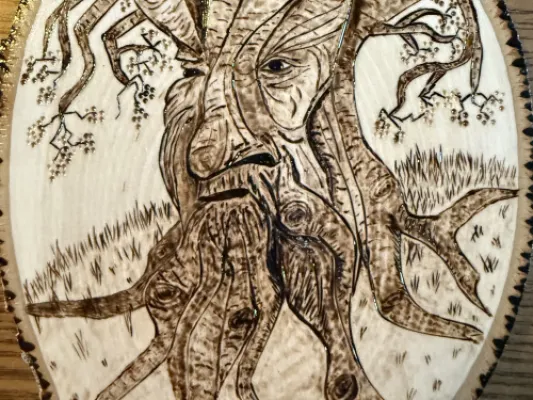 Wood-burned picture of tree face