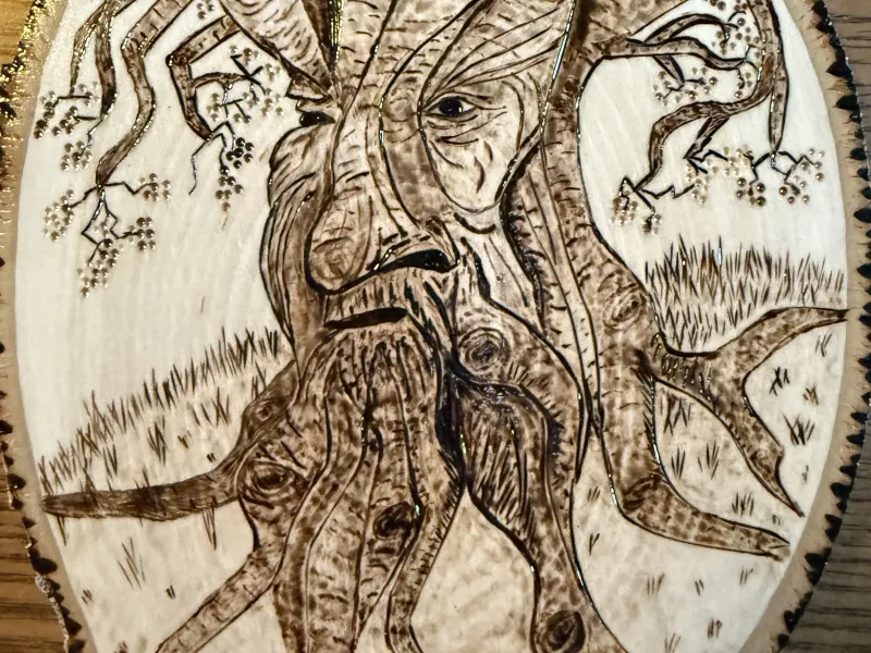 Wood-burned picture of tree face
